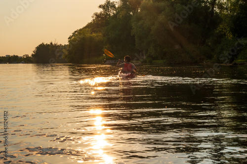 Sea kayaker heading into the setting sun on Long Pond on the Toronto Islands. © Michael Connor Photo