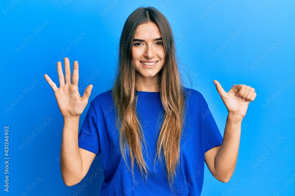 Young hispanic woman wearing casual clothes showing and pointing up with fingers number six while smiling confident and happy. Young hispanic woman wearing casual clothes showing and pointing up with fingers number six while smiling confident and happy.