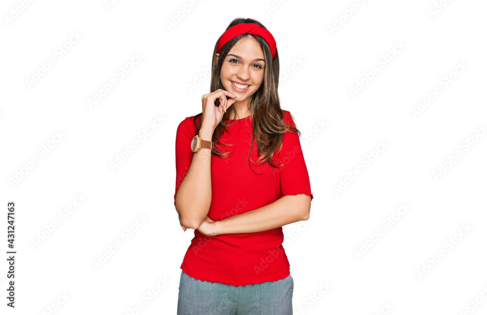 Young brunette woman wearing casual clothes looking confident at the camera smiling with crossed arms and hand raised on chin. thinking positive.