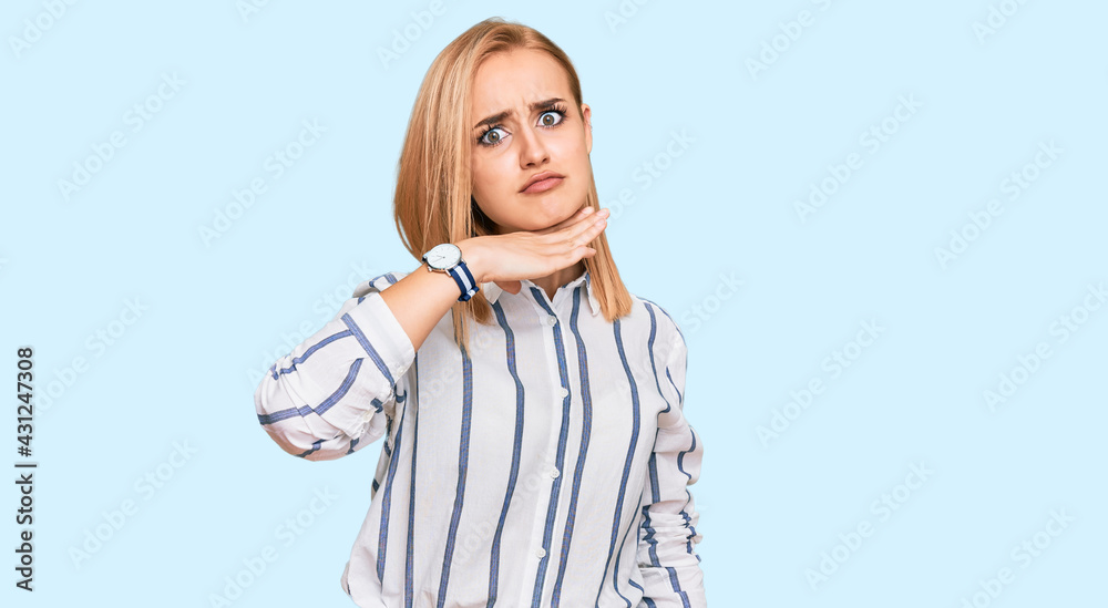 Beautiful caucasian woman wearing casual clothes cutting throat with hand as knife, threaten aggression with furious violence Beautiful caucasian woman wearing casual clothes cutting throat with hand as knife, threaten aggression with furious violence