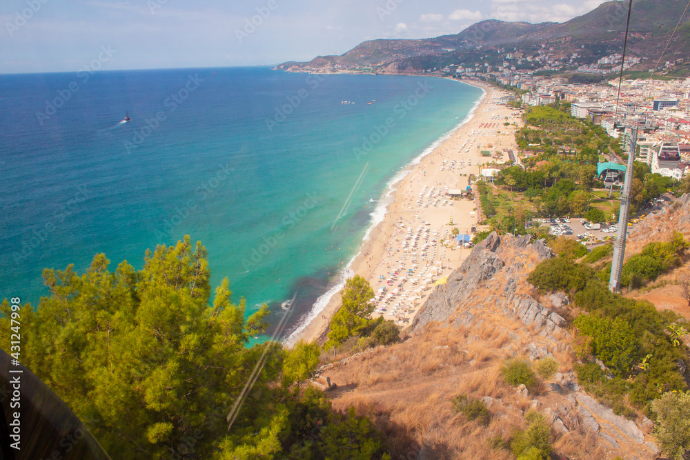 Beach in Alanya, Turkey. View and heights, top view. Blue sea in summer. Vacation in Turkey. Cleopatra beach.