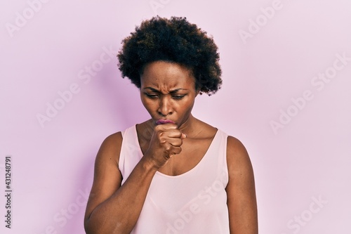 Young african american woman wearing casual sleeveless t shirt feeling unwell and coughing as symptom for cold or bronchitis. health care concept. © Krakenimages.com