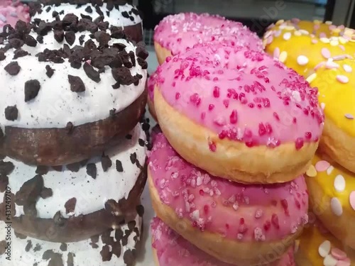 Moving along a bakery shop window with color mixed doughnut