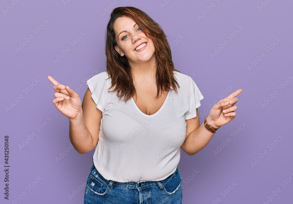 Young plus size woman wearing casual white t shirt smiling confident pointing with fingers to different directions. copy space for advertisement Young plus size woman wearing casual white t shirt smiling confident pointing with fingers to different directions. copy space for advertisement