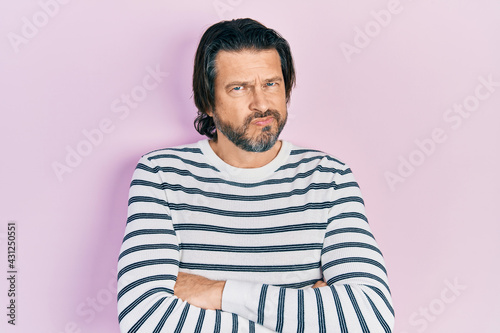 Middle age caucasian man wearing casual clothes skeptic and nervous, disapproving expression on face with crossed arms. negative person.