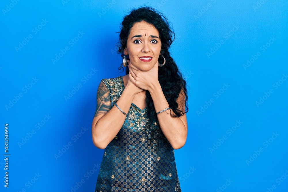 Young woman wearing bindi and traditional kurta dress shouting and suffocate because painful strangle. health problem. asphyxiate and suicide concept. Young woman wearing bindi and traditional kurta dress shouting and suffocate because painful strangle. health problem. asphyxiate and suicide concept.