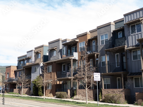 Regular street scene without people in a housing area with multiple units including condo or townhouse with balcony or veranda without people in Boulder, Colorado
