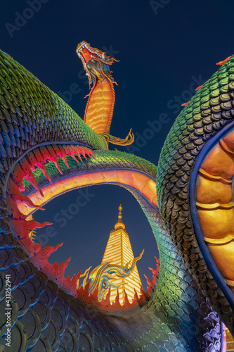 Serpent statue sculpture of chedi stupa pagoda Buddhism in Wat Phra That Nong Bua Dhammyuttika temple, Ubon Ratchathani district, Thailand. photo