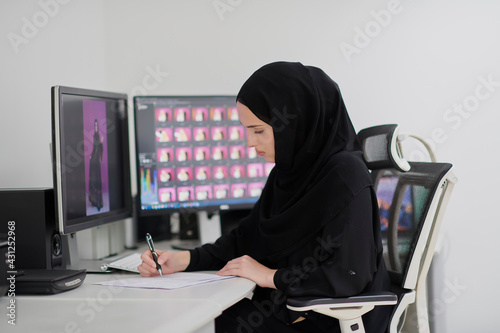 Muslim female graphic designer working on computer