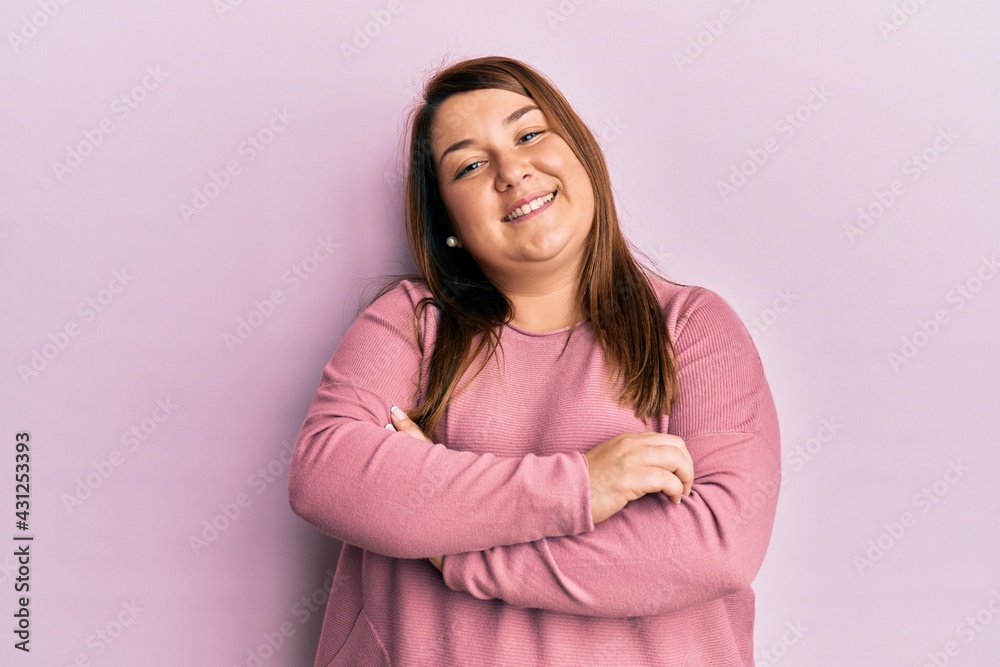 Obraz premium Beautiful brunette plus size woman wearing casual winter sweater happy face smiling with crossed arms looking at the camera. positive person.