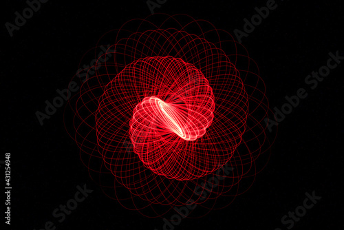 Wonderful and abstract round and parabolic patterns draw different light paths with LED ball lights on a dark background, pendulum.
