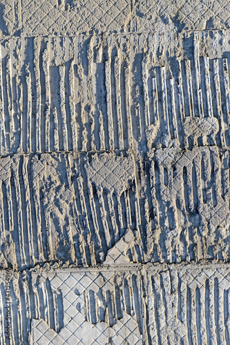 abstract uneven embossed textured concrete wall, stone material texture closeup