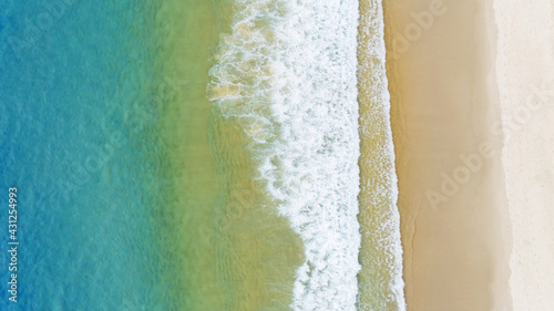 Aerial view of the Gradient color of Ocean surface with waves washing on the coast of the Andaman ocean Amazing top down nature Landscape seascape view beautiful for travel background and website