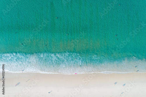Aerial view of the Turquoise color of Ocean surface with waves washing on the coast of the Andaman ocean Amazing top down nature Landscape seascape view beautiful for travel background and website