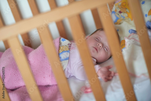 newborn baby sleeping at home in bed