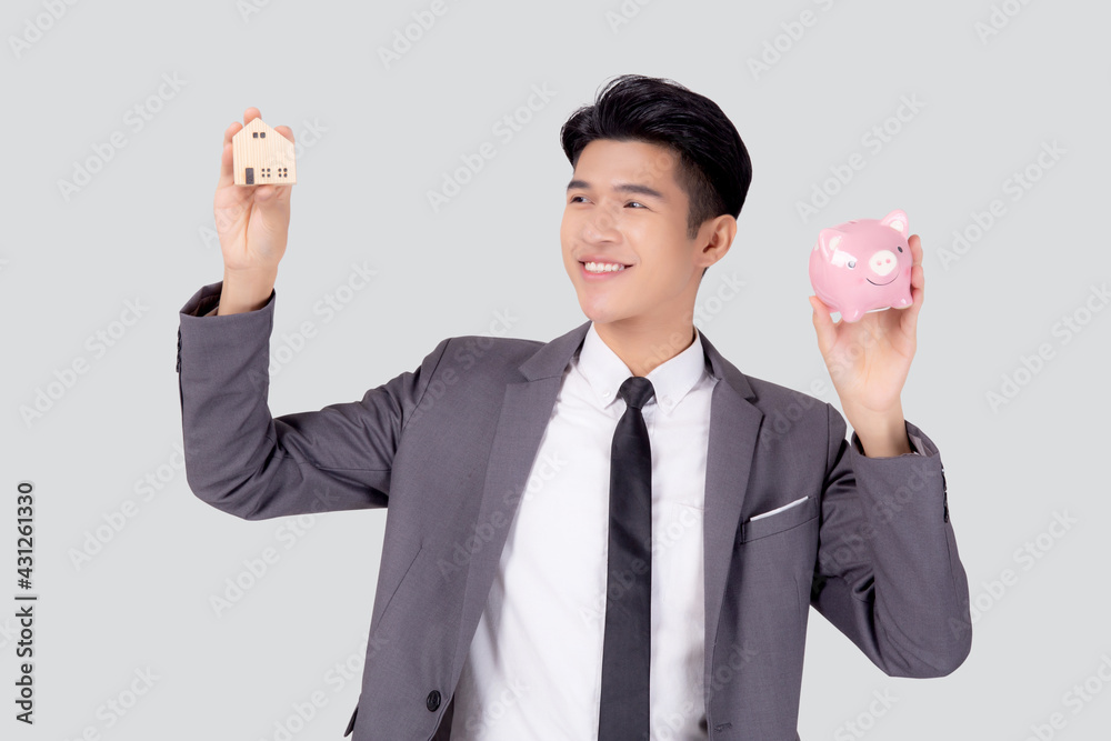 Young asian business man holding home and piggy bank for planning saving future, insurance agent and credit, debt and loan of finance, purchase home and refinance, investment about real property. Young asian business man holding home and piggy bank for planning saving future, insurance agent and credit, debt and loan of finance, purchase home and refinance, investment about real property.