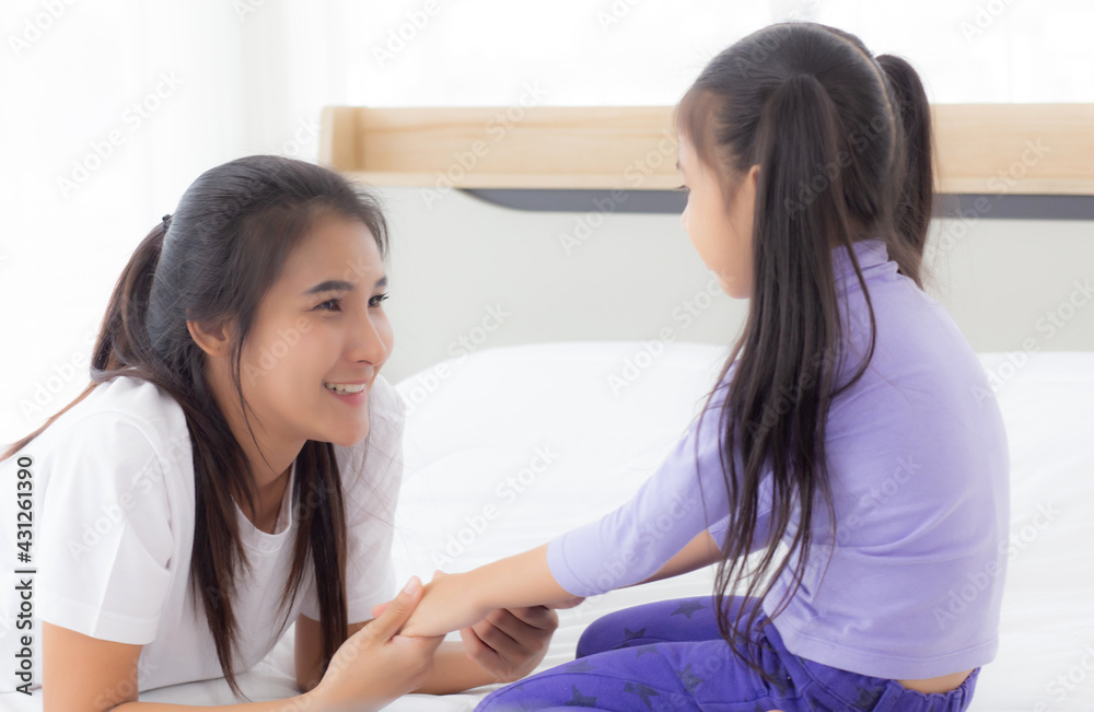 Young asian mom and daughter smiling and eye contact together with care in room, face of mother and girl looking eye with relationship and bonding, emotion and expression, family and love concept. Young asian mom and daughter smiling and eye contact together with care in room, face of mother and girl looking eye with relationship and bonding, emotion and expression, family and love concept.