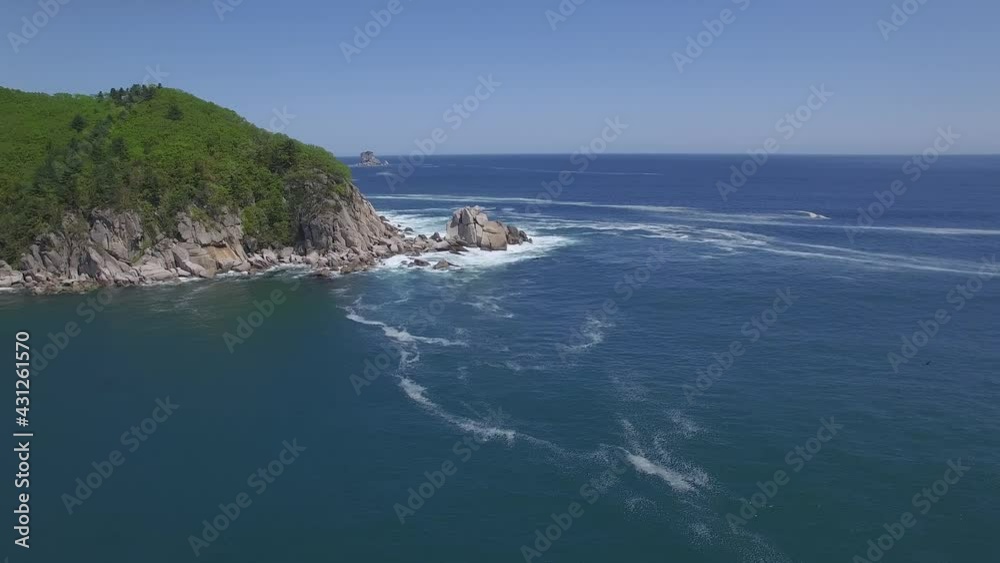 View from a droneon a stone cape washed by strong waves View from a droneon a stone cape washed by strong waves
