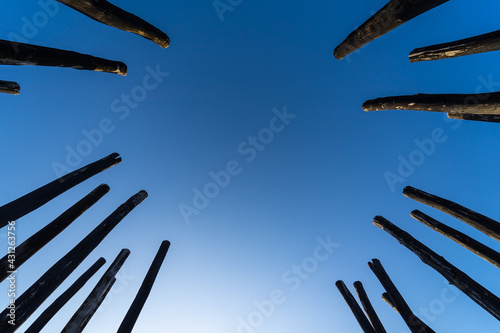 Old wooden pillars against the sky. Background.