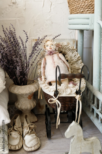 close-up of a vintage porcelain doll lies in a stroller