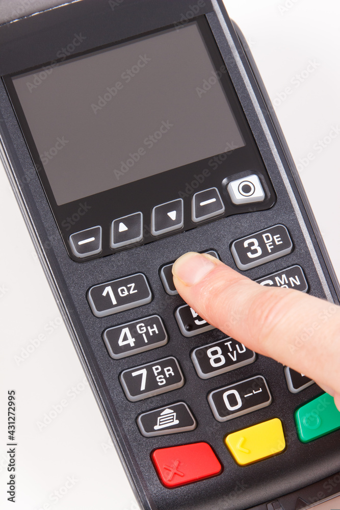Hand of woman entering PIN code on payment terminal. Cashless paying for shopping. Finance concept Hand of woman entering PIN code on payment terminal. Cashless paying for shopping. Finance concept