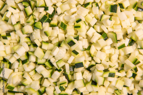 Chopped raw zucchini, close-up, diced zucchini macedonia. High quality photo