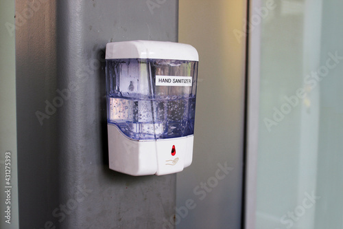 Hand sanitizer. Hand sanitizer in a public place against a wall in a public place.