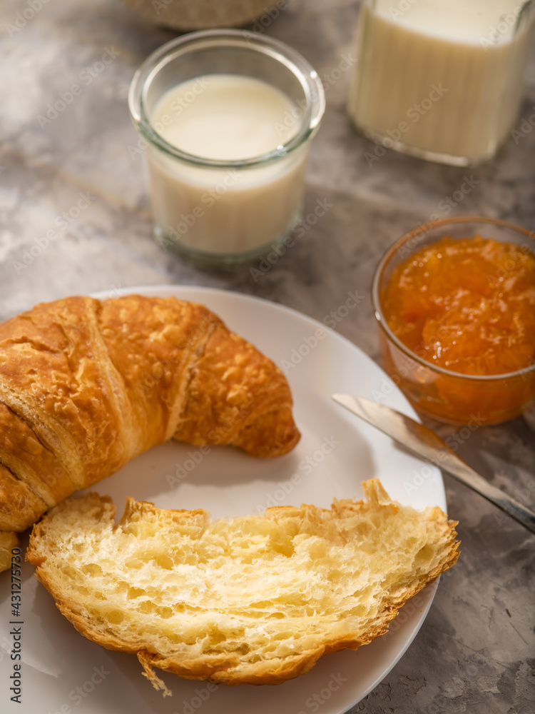 Morning breakfast with croissants, orange jam and milk. Morning light Morning breakfast with croissants, orange jam and milk. Morning light