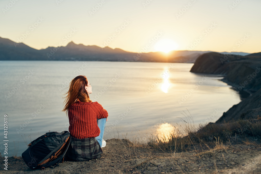 woman near the sea on nature landscape sunset mountains model