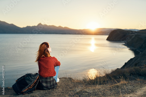 woman near the sea on nature landscape sunset mountains model