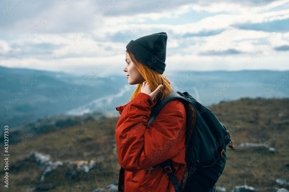 woman travels in the mountains landscape backpack red jacket and hat model woman travels in the mountains landscape backpack red jacket and hat model