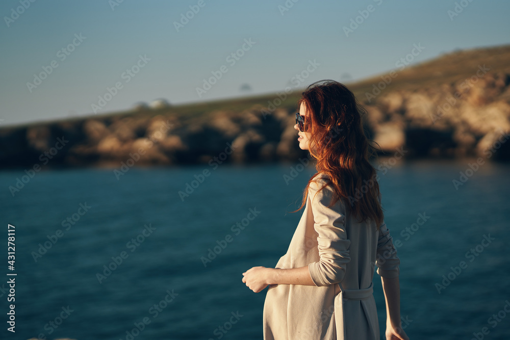 model in glasses woman walking on the beach near the sea in the garage side view model in glasses woman walking on the beach near the sea in the garage side view