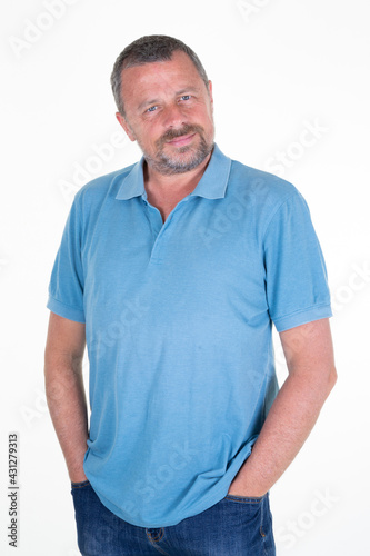 Happy handsome middle aged man standing against white background