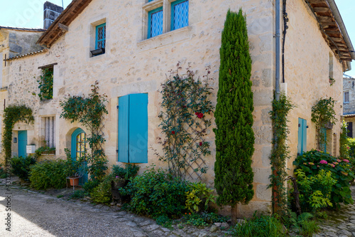 Fototapeta Naklejka Na Ścianę i Meble -  medieval stones house blue shutter in Rions village Gironde France