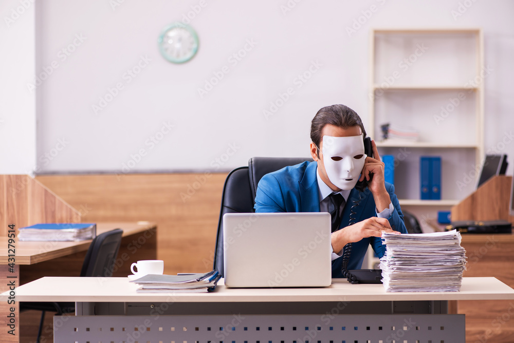 Young male employee wearing masks in the office Young male employee wearing masks in the office