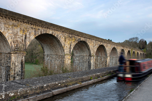 Chirk aqueduct and viaduct on the Llangollen canal, on the border of England and Wales. With a barge narrowboat crossing