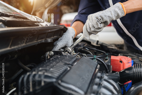 Automobile mechanic repairman hands repairing a car engine automotive workshop with a wrench, car service and maintenance,Repair service.