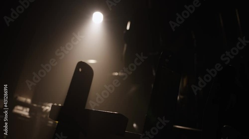 Old machinery working in a hazy, vintage workshop. Gears spinning, metal machines, historical printing studio. Industrial scene, antique, classic letterpress studio, making books, precision and art.