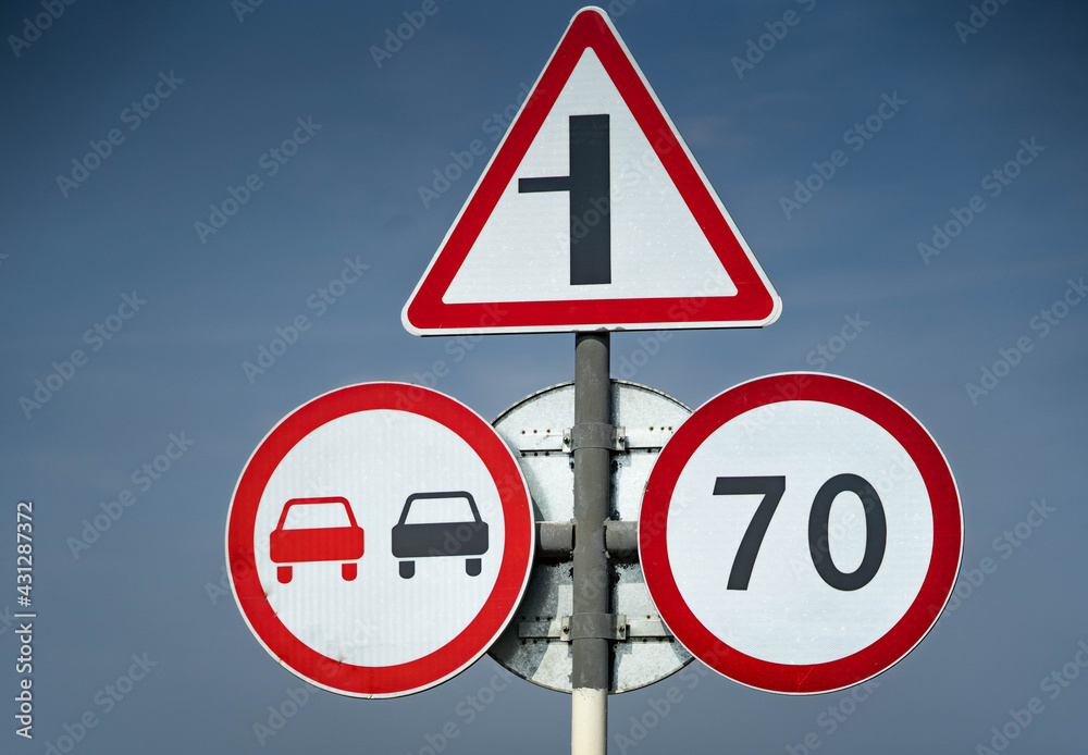 road sign overtaking is prohibited. road sign speed limit 70 km per hour. road sign turn right