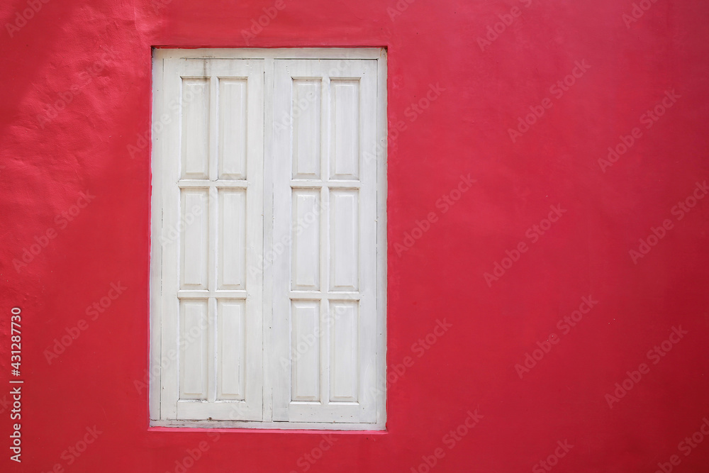 Old white wood window on red wall
