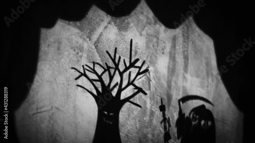 Vintage animation, shadow theatre on a wall. Pantomime, fantasy story. Halloween scene, black and white storytelling. Classic fable for children, creepy puppets.