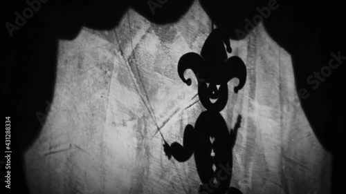 Vintage animation, shadow theatre on a wall. Pantomime, fantasy story. Halloween scene, black and white storytelling. Classic fable for children, creepy puppets.