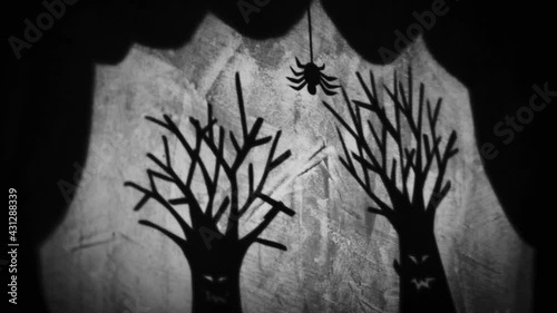 Vintage animation, shadow theatre on a wall. Pantomime, fantasy story. Halloween scene, black and white storytelling. Classic fable for children, creepy puppets.