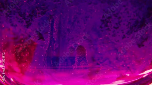 Abstract, colorful liquids moving in slow motion, bright, vivid background. Flowing colors, splashing on screen, motion graphics wallpaper.