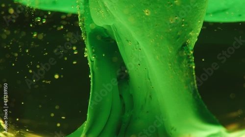 Macro shot of a strange, glowing mushroom. Biology, microcosmos, growth and creativity. Abstract background, colorful liquids flowing in slow motion, nature.