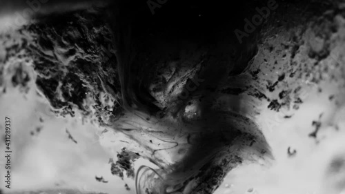 Abstract, gritty black and white background. Horror, thriller background, eerie moving substances in slow motion. Creepy macro scene.