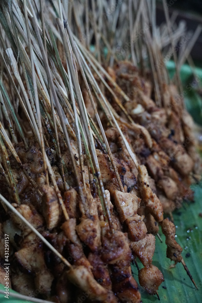 Close-up of delicious chicken satay arranged on tray