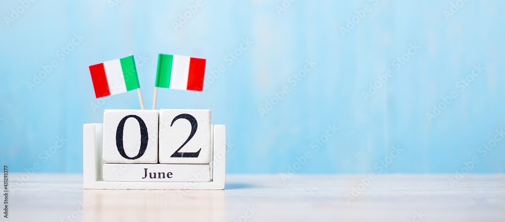 Wooden calendar of June 2nd with miniature Italy flags. National Day, Republic Day, Festa della Repubblica and happy celebration concepts