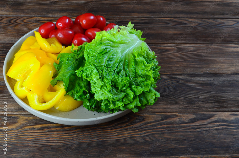 food background ingredients for making summer vegetable salad bell pepper, lettuce and cherry tomatoes, the concept of diet and healthy eating