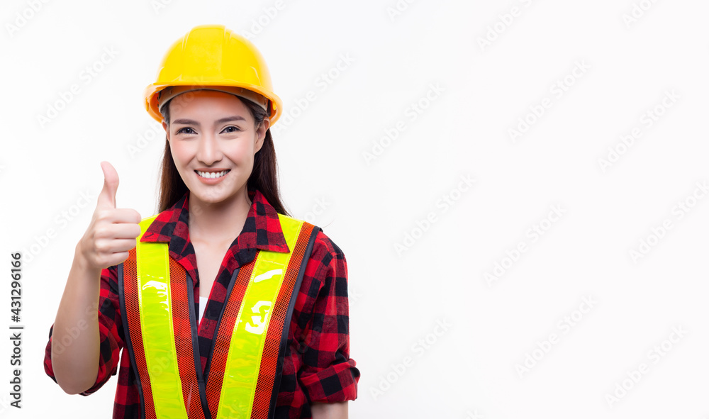 Young worker or engineer person wearing protective helmet reflection vest showing thumbs up with happy and smile face isolated on white background Copy space Smiling female estate adviser portrait Young worker or engineer person wearing protective helmet reflection vest showing thumbs up with happy and smile face isolated on white background Copy space Smiling female estate adviser portrait